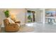 Cozy living room with view of the backyard through sliding glass doors and gray flooring at 608 Ashwell Ct, Debary, FL 32713