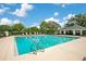 Community pool with ample seating, clear blue water, and beautiful landscaping at 608 Ashwell Ct, Debary, FL 32713