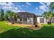 Scenic backyard featuring a screened-in pool area, well-kept lawn, and a storage shed at 641 Lakescape Ct, Orlando, FL 32828