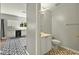 Bathroom with a black and white themed kitchen in the background at 641 Lakescape Ct, Orlando, FL 32828