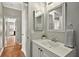 Bathroom with a white vanity and a view to the adjacent kitchen at 641 Lakescape Ct, Orlando, FL 32828