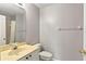 Bathroom with a sink, toilet, mirror, and an enclosed shower at 641 Lakescape Ct, Orlando, FL 32828