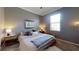 The bedroom features a soft color palette, comfortable queen bed, and bright natural light at 641 Lakescape Ct, Orlando, FL 32828
