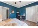 Bedroom featuring blue walls, a desk, carpet floors, and a closet at 641 Lakescape Ct, Orlando, FL 32828