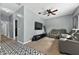 Finished bonus room featuring vinyl patterned floors, a gray leather sofa, and tv at 641 Lakescape Ct, Orlando, FL 32828