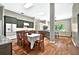 Open-concept dining room featuring modern green cabinets and a large dining table with seating for eight at 641 Lakescape Ct, Orlando, FL 32828