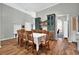 Bright dining area featuring wood floors, custom cabinetry, and a view of a study at 641 Lakescape Ct, Orlando, FL 32828