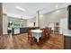 Open-concept kitchen and dining area featuring wood floors and modern appliances at 641 Lakescape Ct, Orlando, FL 32828