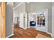 Hallway with wood floors, leading to a room with glass doors and a comfortable blue couch at 641 Lakescape Ct, Orlando, FL 32828