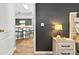 View from the main bedroom to the kitchen with a white island and barstool seating at 641 Lakescape Ct, Orlando, FL 32828