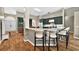 Open concept kitchen with bar seating, modern appliances, and custom cabinetry at 641 Lakescape Ct, Orlando, FL 32828