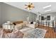 Open concept living room with hardwood floors, comfortable seating, a stylish kitchen island, and abundant natural light at 641 Lakescape Ct, Orlando, FL 32828