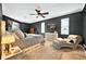 Comfortable main bedroom with dark walls, soft carpet, ceiling fan, and natural light to create a cozy retreat at 641 Lakescape Ct, Orlando, FL 32828