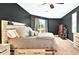 Serene main bedroom with hardwood floors, a ceiling fan, soft carpet, and natural light to create a relaxing retreat at 641 Lakescape Ct, Orlando, FL 32828