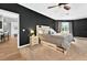A relaxing main bedroom offers hardwood floors, soft carpet, a ceiling fan, and natural light at 641 Lakescape Ct, Orlando, FL 32828