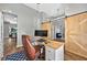 A home office with a wooden desk, leather chair, and sliding barn doors for added privacy at 641 Lakescape Ct, Orlando, FL 32828