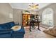 Comfortable home office with a stylish blue couch, shelving, and a well-lit workspace at 641 Lakescape Ct, Orlando, FL 32828