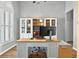 Well-lit office with built-in shelving, large windows, and a bright wooden desk with gray accents at 641 Lakescape Ct, Orlando, FL 32828