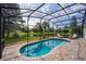 Screened in pool featuring brick pavers and a view of the pond at 641 Lakescape Ct, Orlando, FL 32828