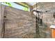 Glass-enclosed shower features marble tile surround with pebble accents and a rainfall showerhead at 641 Lakescape Ct, Orlando, FL 32828
