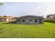 Backyard featuring a large screened-in patio at 657 Mckinley Ct, Kissimmee, FL 34758