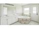 Bathroom with double sink vanity, a tiled corner tub, and tile flooring at 657 Mckinley Ct, Kissimmee, FL 34758