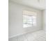 This bedroom with tiled floors and a window to the screened-in porch at 657 Mckinley Ct, Kissimmee, FL 34758
