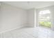 Bedroom featuring tiled floors and a large arched window at 657 Mckinley Ct, Kissimmee, FL 34758