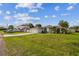 A white single-story home featuring an attached garage and front yard at 657 Mckinley Ct, Kissimmee, FL 34758