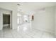Spacious living area with tile floors, arched windows, kitchen bar, and bathroom view at 657 Mckinley Ct, Kissimmee, FL 34758