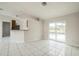Open-plan living area with bar counter and sliding glass doors to the backyard pool at 657 Mckinley Ct, Kissimmee, FL 34758