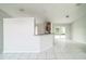 Bright room with tiled flooring and view of kitchen with sliding glass door to backyard at 657 Mckinley Ct, Kissimmee, FL 34758
