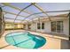 The kidney shaped pool sits off of the back of the home, surrounded by a screened enclosure at 657 Mckinley Ct, Kissimmee, FL 34758