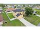 Aerial view of two-story home with a landscaped yard, long driveway and fenced backyard at 670 Bluebill Ct, Poinciana, FL 34759
