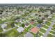 An aerial perspective of a residential area featuring a mix of homes and landscaped yards at 670 Bluebill Ct, Poinciana, FL 34759