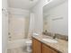 The bathroom features a shower-tub combo, granite countertop, and a modern toilet at 670 Bluebill Ct, Poinciana, FL 34759