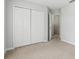 Neutral bedroom with carpet and closet with folding doors; door leads to another room at 670 Bluebill Ct, Poinciana, FL 34759