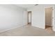 Bedroom features neutral carpet and paint and two doors, one to the closet at 670 Bluebill Ct, Poinciana, FL 34759