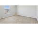 Carpeted bedroom features a large window letting in natural light at 670 Bluebill Ct, Poinciana, FL 34759