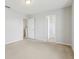Neutral bedroom with carpet and two doors: one to a closet and one to another room at 670 Bluebill Ct, Poinciana, FL 34759