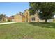 Charming two-story home with an attached garage, well maintained lawn, and a mature tree at 670 Bluebill Ct, Poinciana, FL 34759