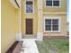 Close up of a two-story home's front entrance, showcasing a modern door and well-maintained landscaping at 670 Bluebill Ct, Poinciana, FL 34759