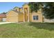 Two-story home with a two-car garage, well-kept lawn, and clear blue skies at 670 Bluebill Ct, Poinciana, FL 34759