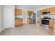 Kitchen featuring tile flooring, stainless steel appliances and wood cabinets at 670 Bluebill Ct, Poinciana, FL 34759