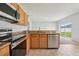 Kitchen featuring granite countertops, stainless steel appliances, and tile flooring at 670 Bluebill Ct, Poinciana, FL 34759
