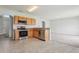 Kitchen featuring tile flooring, stainless steel appliances and wood cabinets at 670 Bluebill Ct, Poinciana, FL 34759