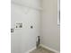The laundry room features tile flooring, gray walls, and a utility shelf at 670 Bluebill Ct, Poinciana, FL 34759