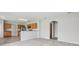 View of carpeted living room from kitchen with stainless steel appliances and wood cabinets at 670 Bluebill Ct, Poinciana, FL 34759