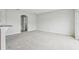 View of carpeted living room from kitchen at 670 Bluebill Ct, Poinciana, FL 34759