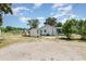 Backyard features a storage shed, patio, and mature tree at 6957 Plymouth Sorrento Rd, Apopka, FL 32712
